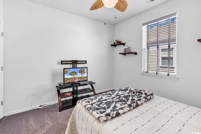 carpeted bedroom featuring multiple windows and ceiling fan