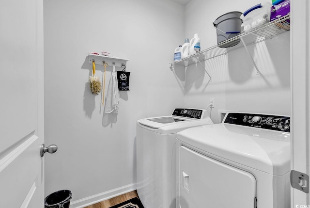 washroom with light hardwood / wood-style floors and independent washer and dryer