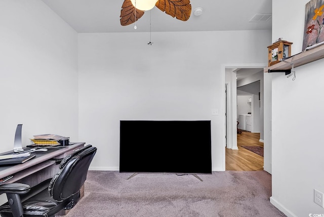 office area featuring washer / dryer, carpet, and ceiling fan