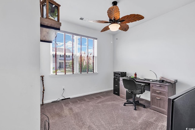 carpeted home office featuring ceiling fan