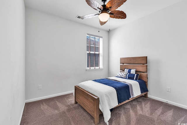 bedroom with ceiling fan and dark colored carpet