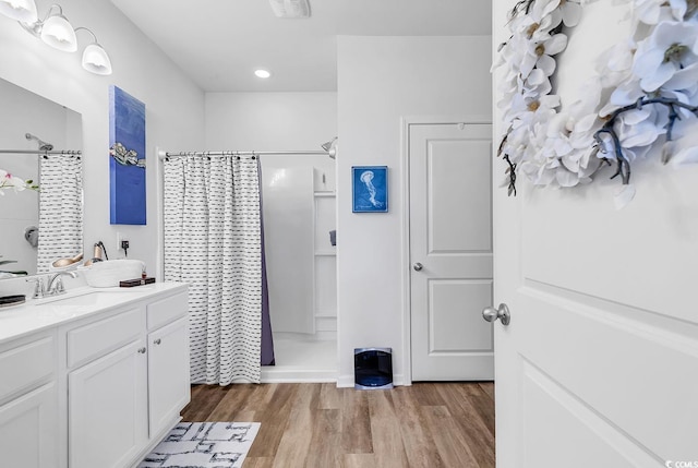 bathroom with vanity, a shower with shower curtain, and wood-type flooring