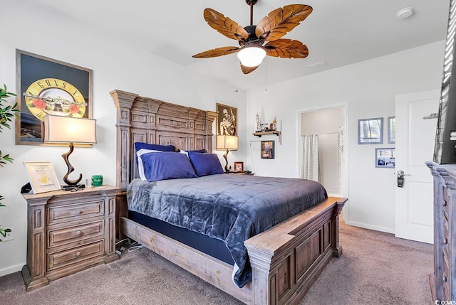 bedroom featuring carpet, ensuite bath, and ceiling fan