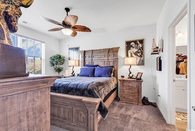 bedroom with connected bathroom, ceiling fan, and carpet floors