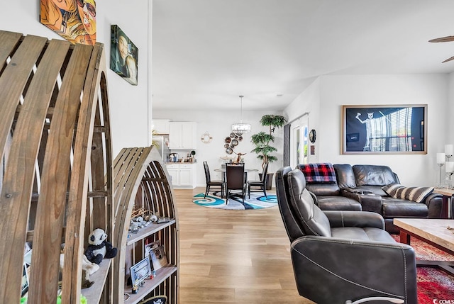 living room featuring ceiling fan and light hardwood / wood-style floors