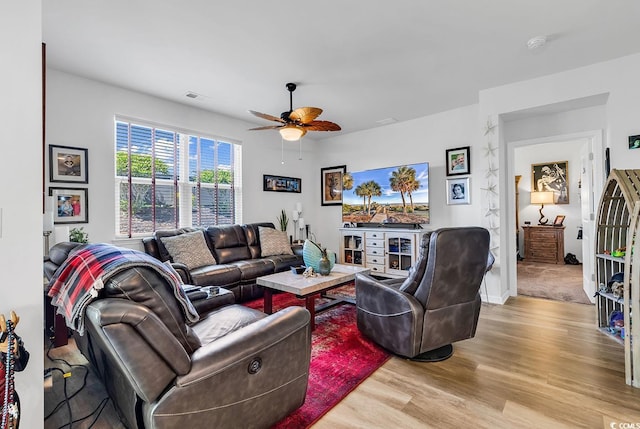 living room featuring ceiling fan and light hardwood / wood-style floors