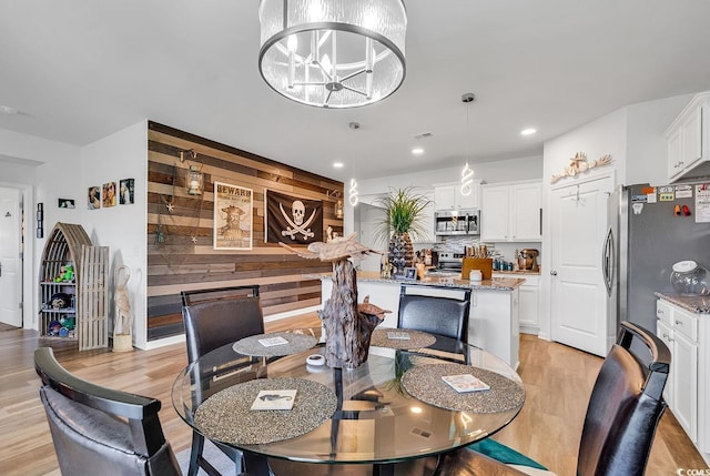 dining area featuring a chandelier and light hardwood / wood-style floors