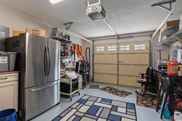 garage with a garage door opener and stainless steel refrigerator