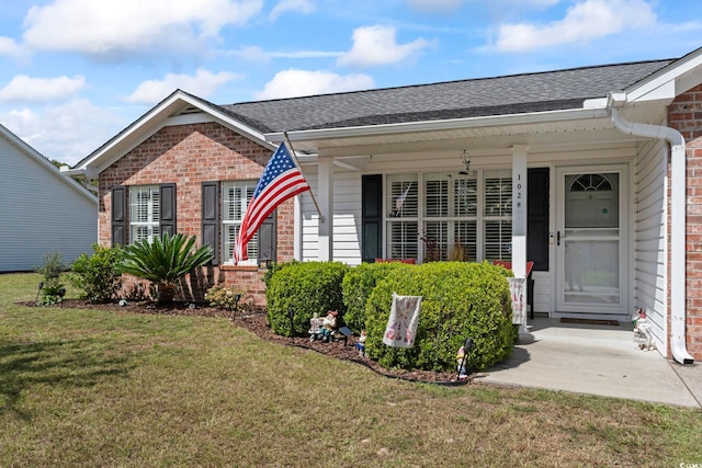 view of front of house with a front yard and a porch