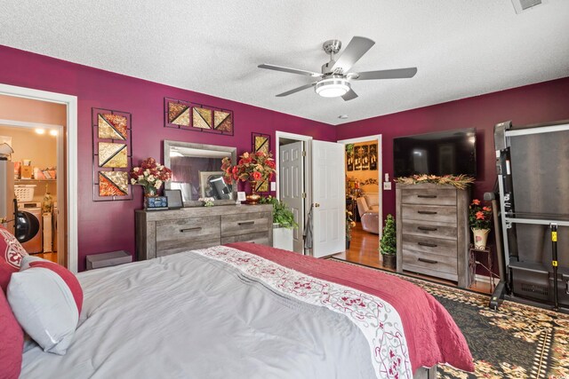 bedroom featuring a textured ceiling, wood-type flooring, and ceiling fan