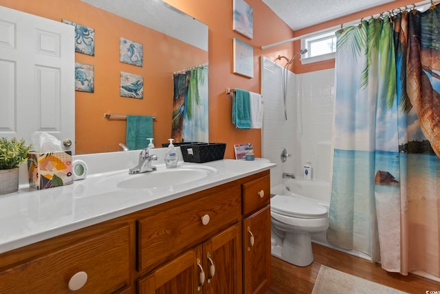 full bathroom featuring a textured ceiling, vanity, shower / tub combo with curtain, wood-type flooring, and toilet