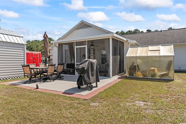 back of house with a lawn, a patio area, and a sunroom