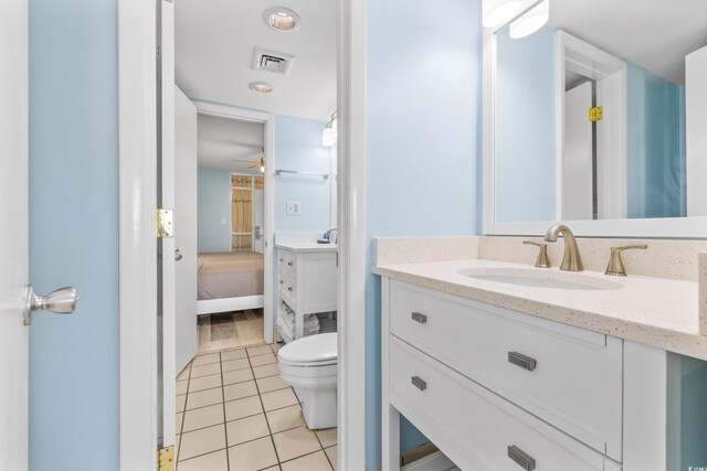 bathroom with vanity, toilet, ceiling fan, and tile patterned flooring