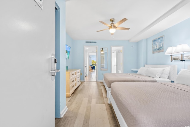 bedroom with visible vents, ceiling fan, baseboards, and light wood-style floors