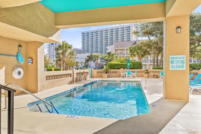 view of swimming pool featuring a patio area