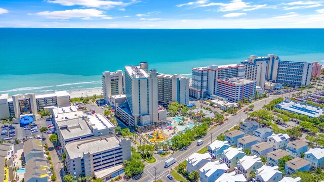 aerial view with a water view and a beach view