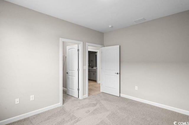 unfurnished bedroom featuring light colored carpet