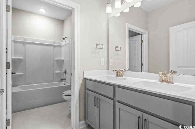 full bathroom with tile patterned floors, toilet, vanity, and washtub / shower combination