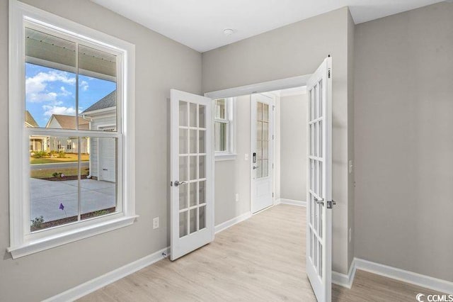 interior space featuring french doors and light wood-type flooring