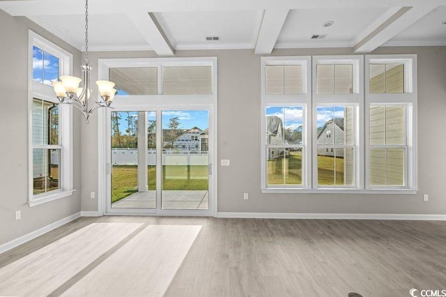 interior space featuring hardwood / wood-style floors, beam ceiling, a wealth of natural light, and a chandelier