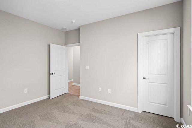 unfurnished bedroom with light colored carpet