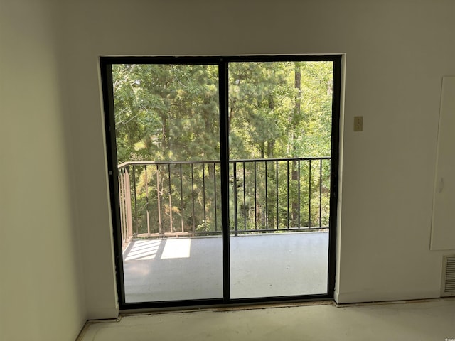 doorway to outside featuring visible vents and concrete floors