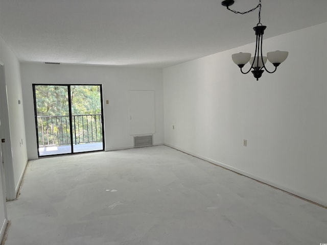 empty room featuring visible vents, concrete floors, and an inviting chandelier