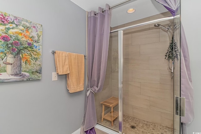 bathroom with a shower with shower door