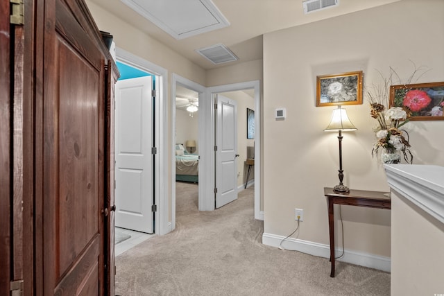 hallway featuring light carpet