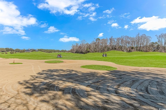 view of property's community featuring a lawn