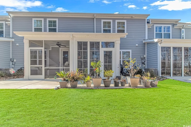 back of property featuring a sunroom, a yard, and a patio area