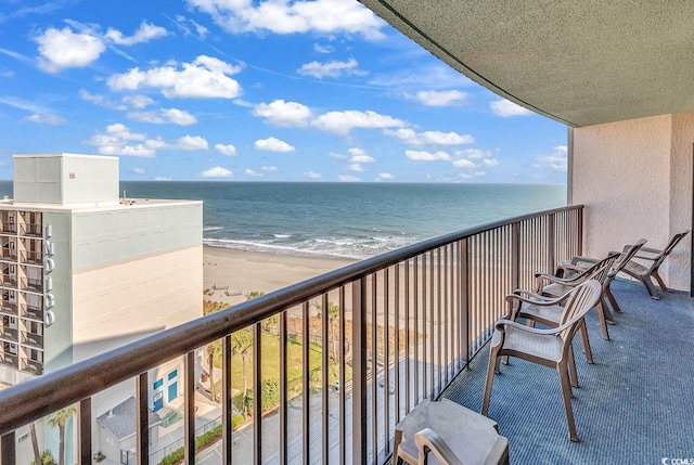 balcony featuring a water view and a beach view