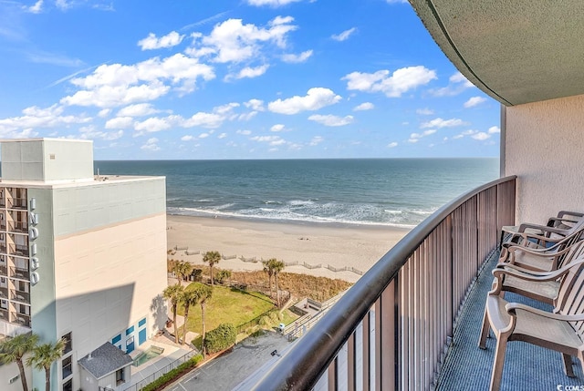 balcony with a water view and a view of the beach