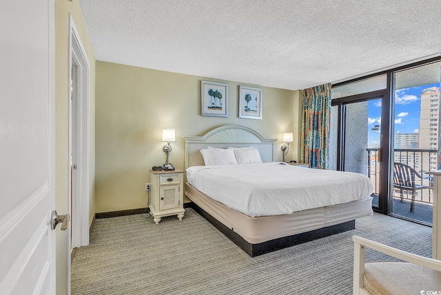 carpeted bedroom featuring a textured ceiling, expansive windows, and access to exterior