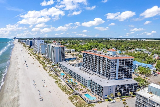 birds eye view of property featuring a water view and a beach view