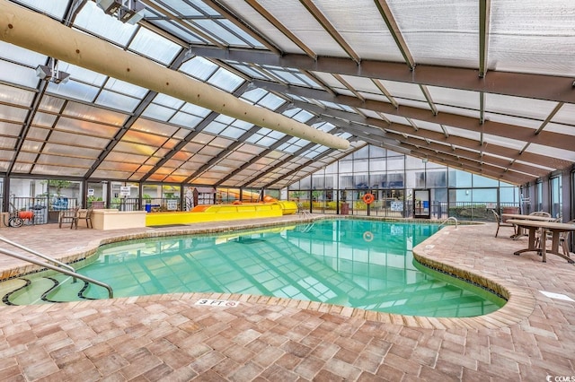 view of swimming pool featuring a lanai and a patio area