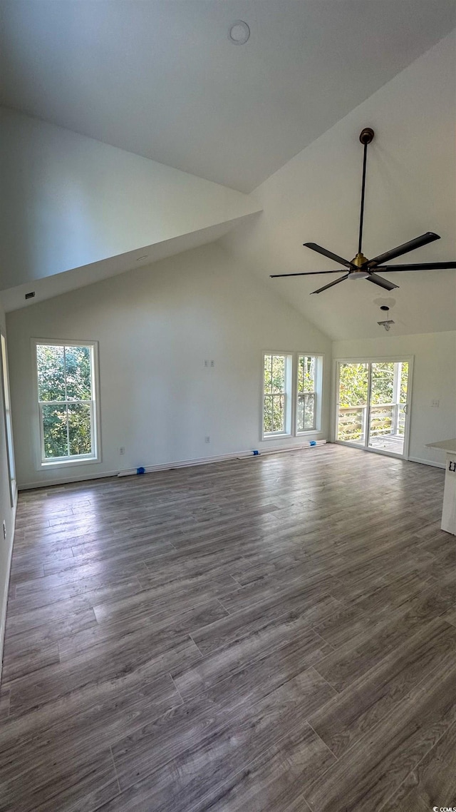 unfurnished living room with hardwood / wood-style floors, a wealth of natural light, and ceiling fan