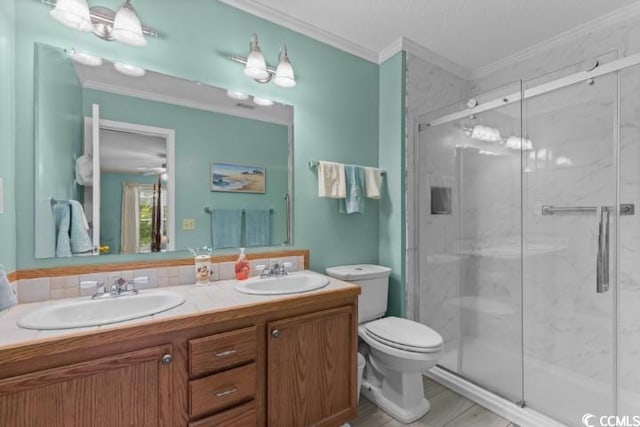 bathroom featuring walk in shower, toilet, crown molding, and vanity