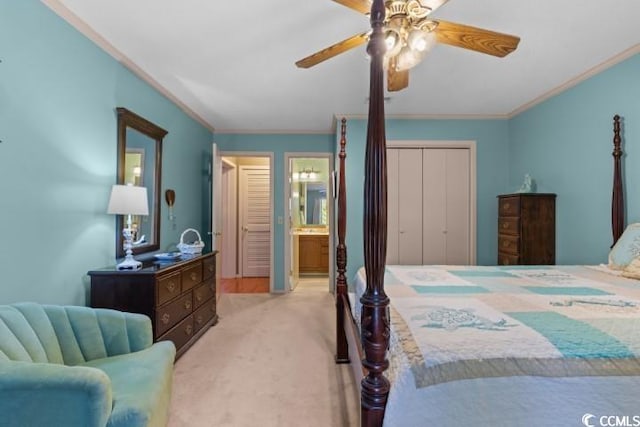 carpeted bedroom with crown molding, ceiling fan, a closet, and ensuite bathroom