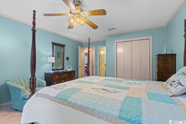 bedroom featuring crown molding, light colored carpet, ceiling fan, and a closet