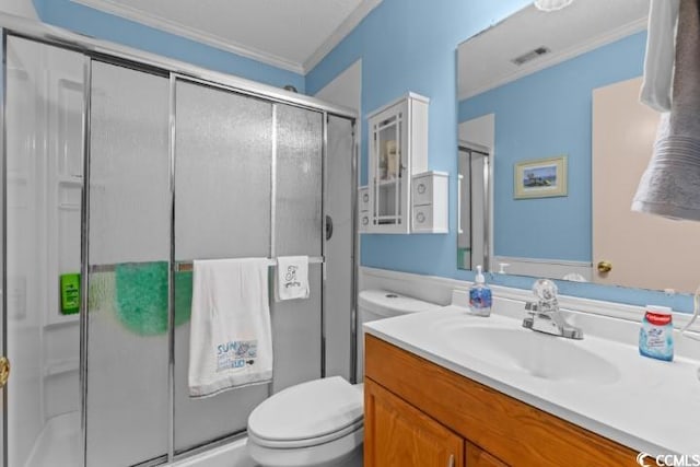 bathroom with vanity, toilet, ornamental molding, and walk in shower