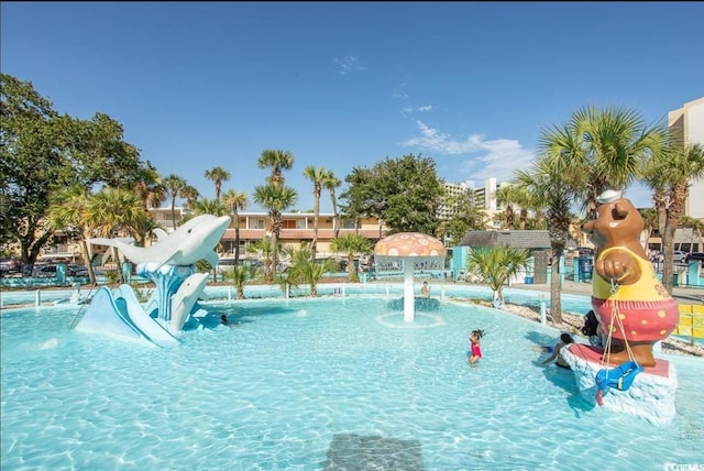 view of pool featuring a water slide and pool water feature