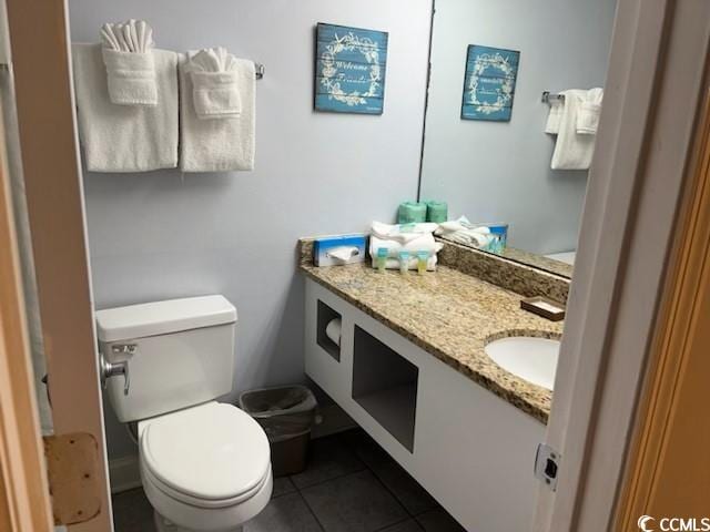 bathroom featuring vanity, toilet, and tile patterned floors