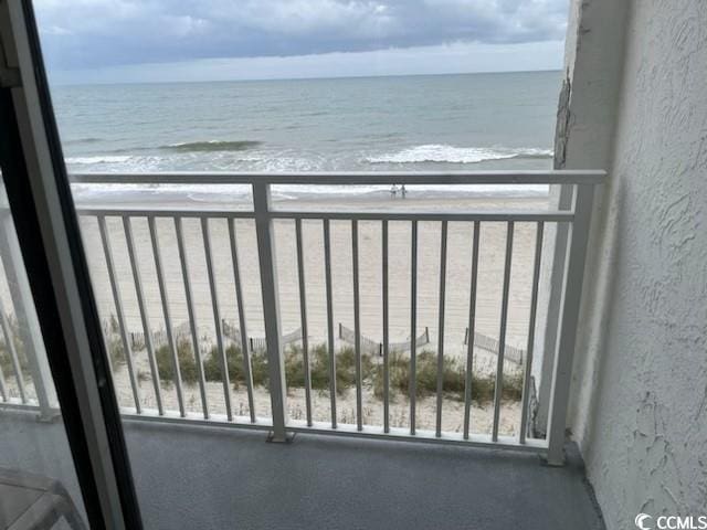 balcony with a view of the beach and a water view