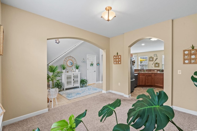 carpeted foyer with sink