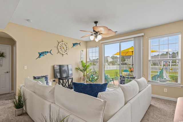 carpeted living room with ceiling fan and plenty of natural light