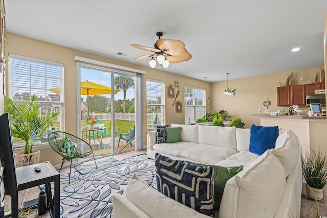 carpeted living room featuring ceiling fan