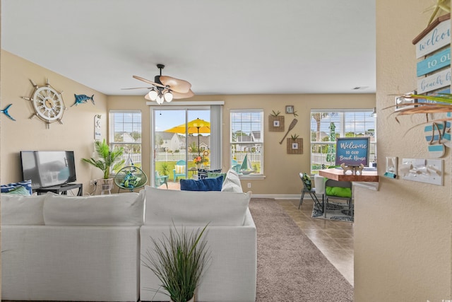 tiled living room featuring ceiling fan