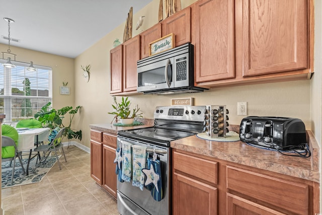 kitchen with appliances with stainless steel finishes and light tile patterned floors