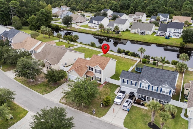 birds eye view of property with a water view